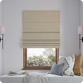 Neutral roman shade above a bedroom bench