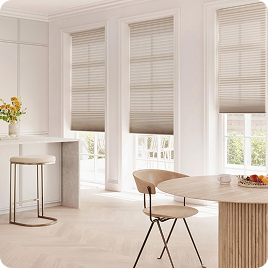 White roman shades in a bright dining area